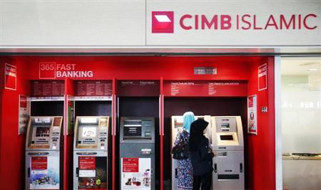 People withdraw cash from an automatic teller machine at a CIMB Islamic branch in Sepang outside Kuala Lumpur August 26, 2013. REUTERS/Bazuki Muhammad