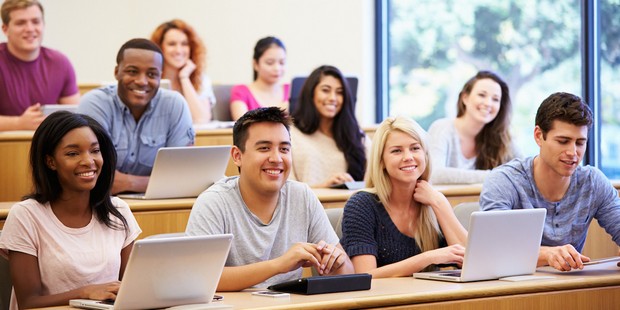 Students Using Laptops And Digital Tablets In Lecture