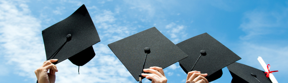 Many hand holding graduation hats on background of blue sky.