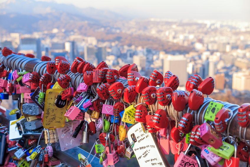 Seoul, South Korea - NOV 9: As a sign of devotion, couples write their names on locks and clip them to a wall at Namsan Tower in Seoul, South Korea. on November 9, 2014