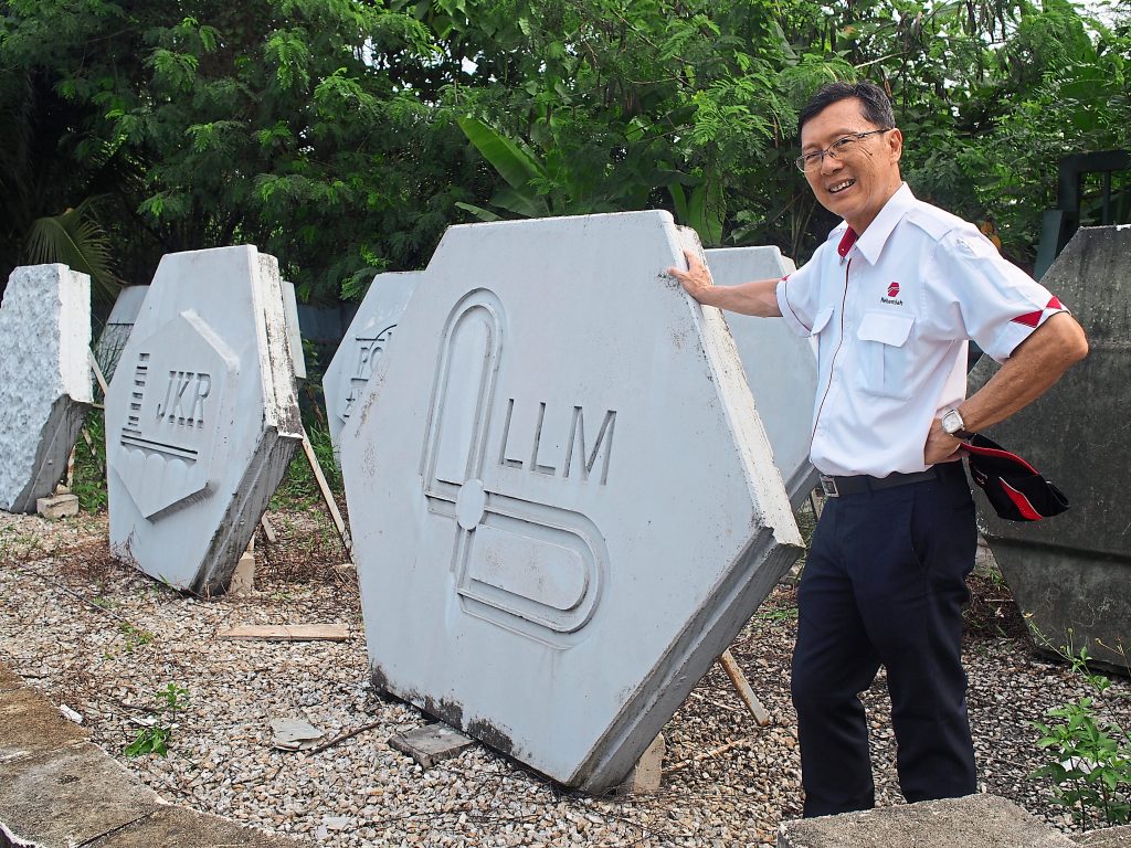 Lee with some facing panels his company makes at their 10-acre casting yard in Kuang, Selangor.