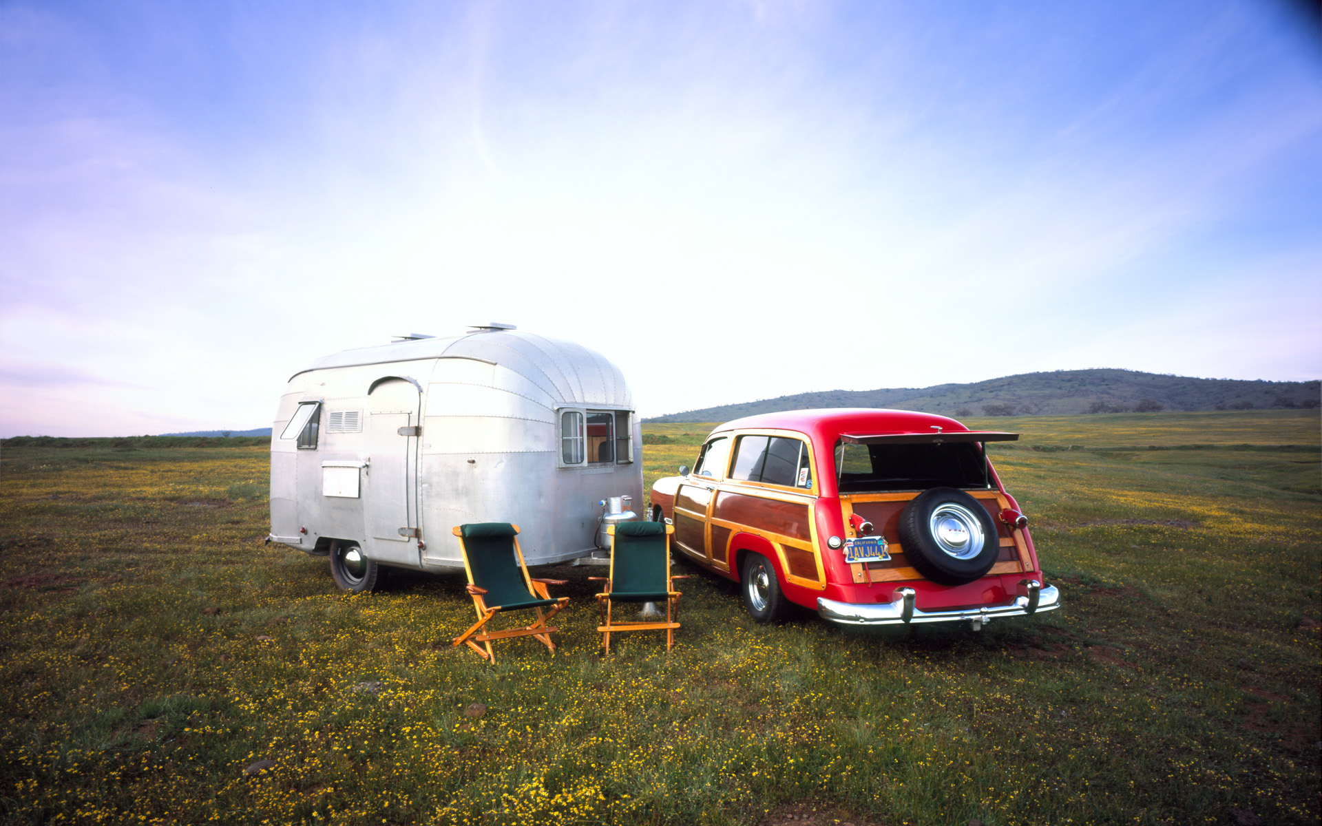 1950 Ford Woody parked next to a 1952 Airstream Cruisette